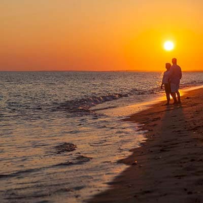 couple on romantic walk on New Seabury beach couple on romantic walk on New Seabury beach